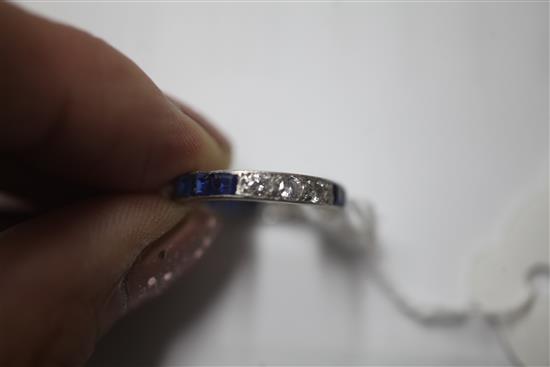 A 1940s/1950s platinum? sapphire and diamond set full eternity ring, size O.